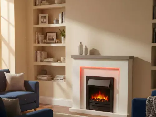 Bempton electric fireplace with white surround, black inset electric fire, colour-changing LED backlighting and realistic flame effect, styled in a cosy living room with sofa and soft lighting.
