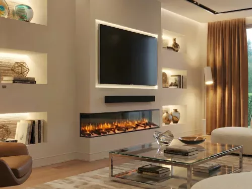 Rosedale media wall electric fire with realistic flame effect beneath a wall-mounted TV, set in a modern luxury living room with built-in shelving and warm LED ambient lighting.